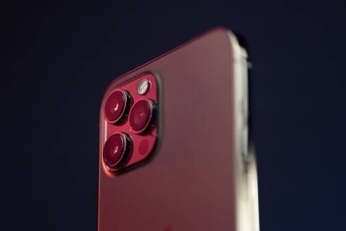 Ein iPhone Pro mit Triple-Kamera iPhone in Rosé vor dunklem Hintergrund