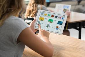 Geräte verwalten mit Apple School Manger Mädchen tippt Apps an auf dem iPad in der Schule