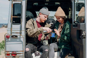 Reisende trinken Kaffee in Geländewagen (Foto: Cottonbro / pexels) Ein Paar beim Kaffe im Van