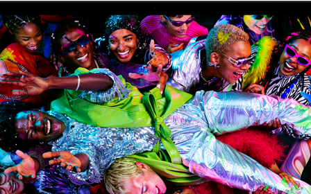 Colorful screen on a MacBook Pro of a person crowdsurfing at a party, showcasing the vibrant Liquid Retina XDR display